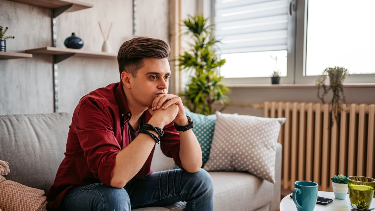 A man sitting on a couch in his living room.