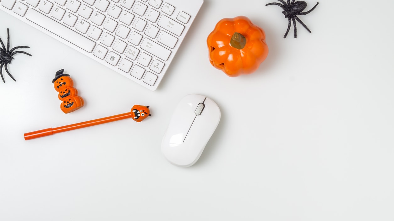 Halloween decorations on a desk with a mouse and keyboard.