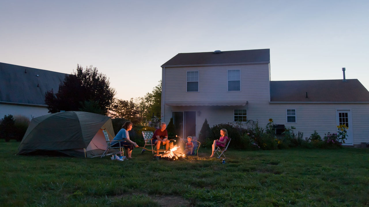 A group of people sitting around a campfire.