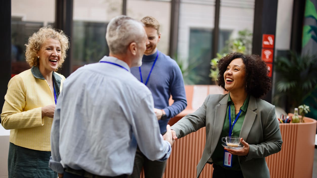 A group of people shaking hands at an event.