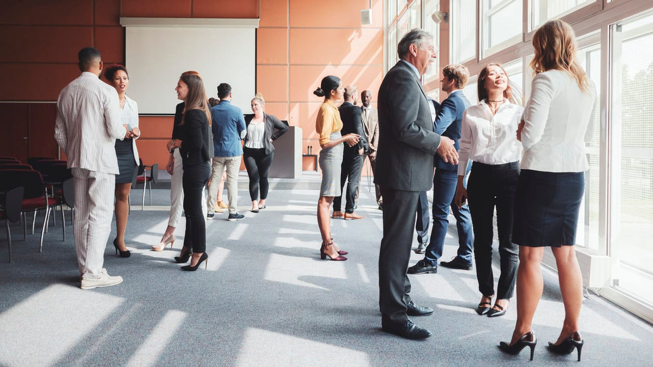 A group of business people standing in a conference room.