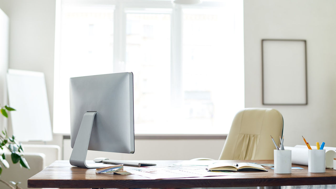 A wooden desk with a plant on it.