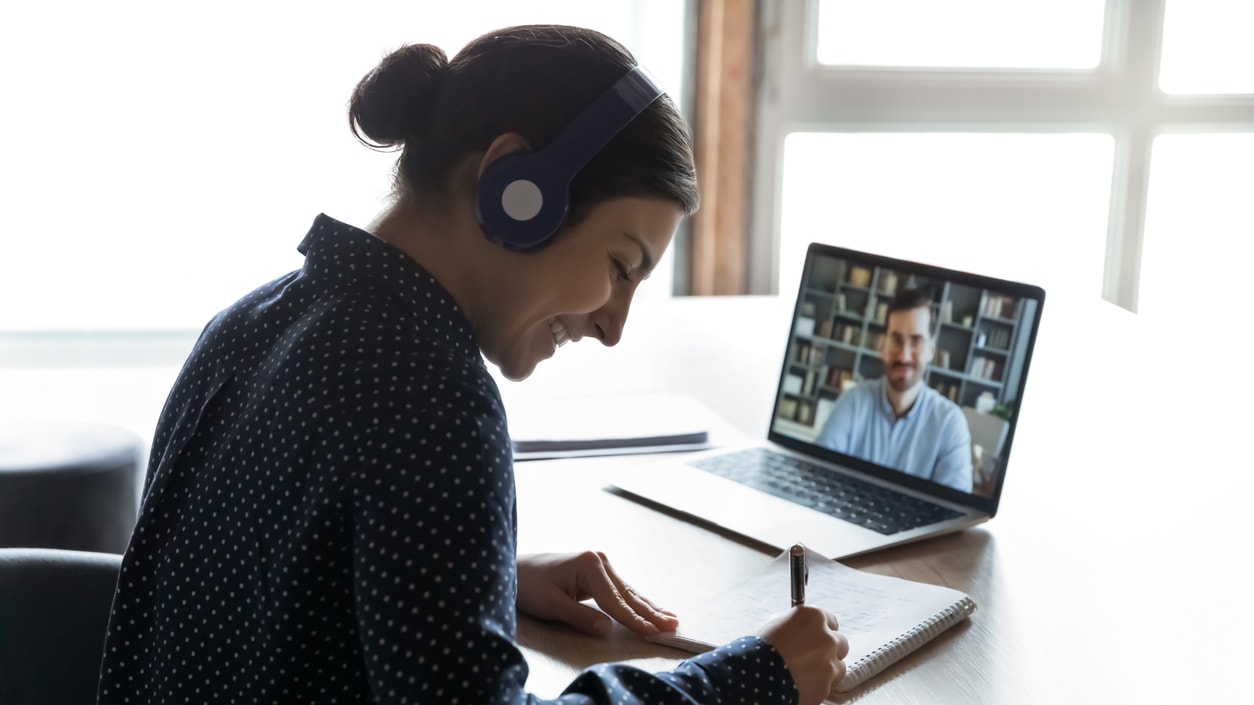 A woman is on a video call with a man on a laptop.