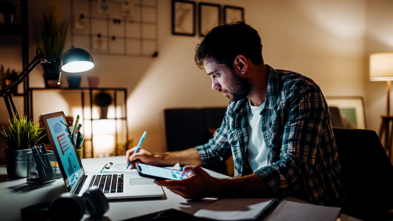 A man working on his laptop at night.