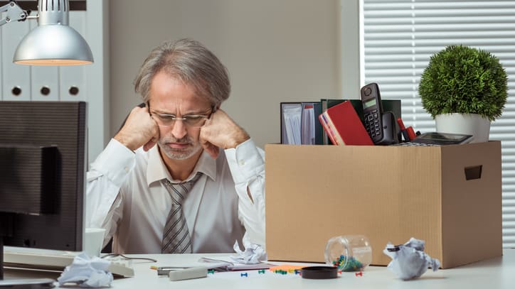 A man sitting at his desk with a box in front of him.