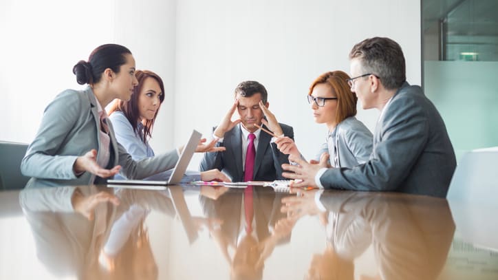 A group of business people sitting around a conference table.