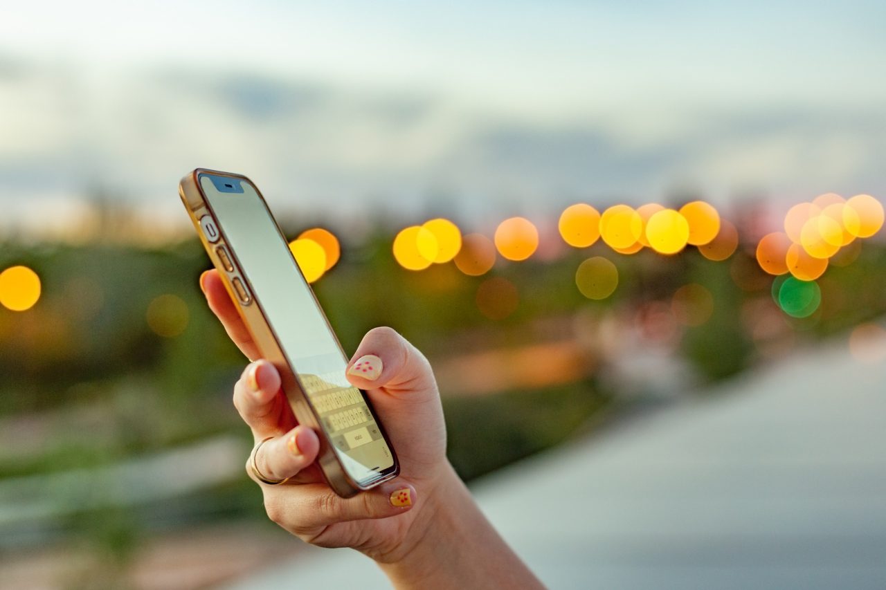 A woman views social media content on their phone.