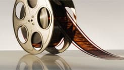 A film reel sitting on a white surface.