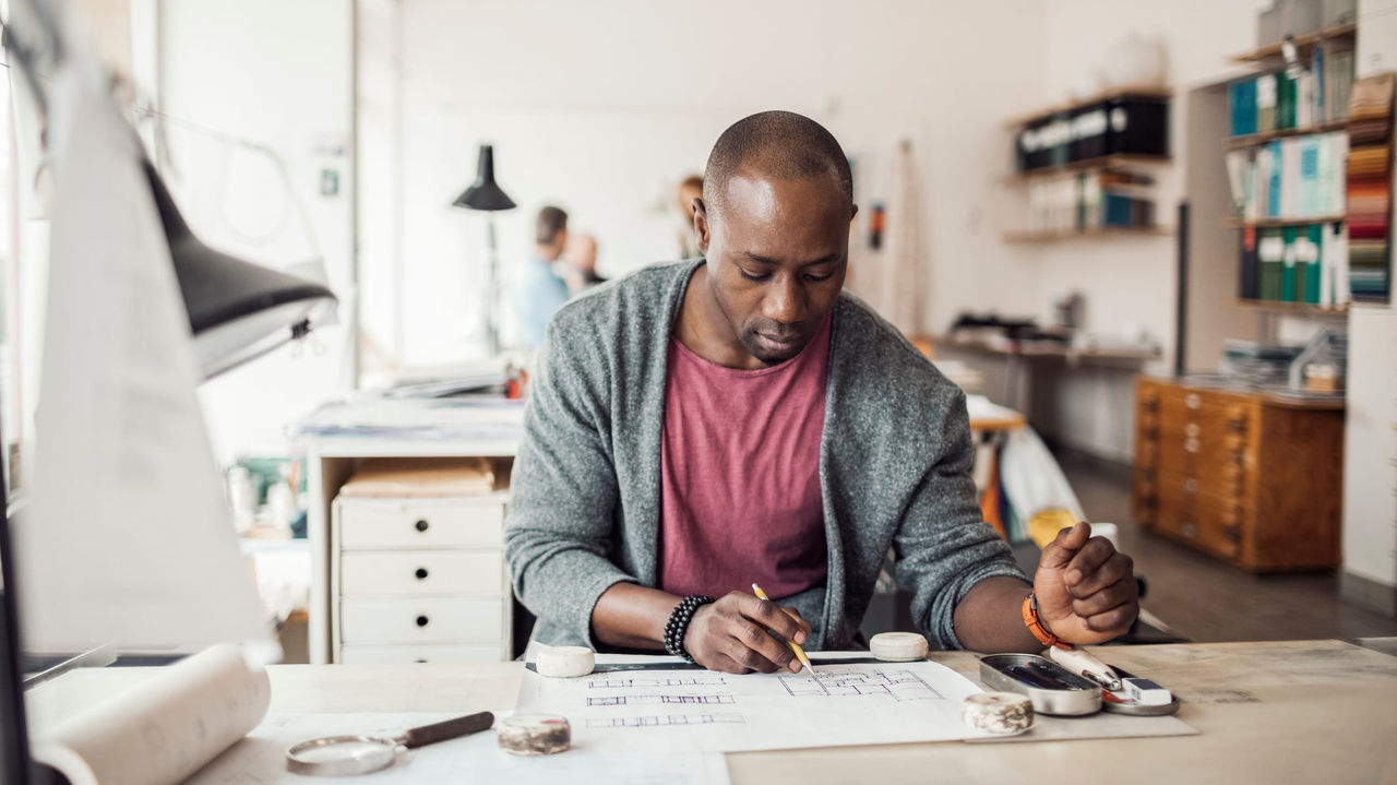 A man is working at a desk in an office.