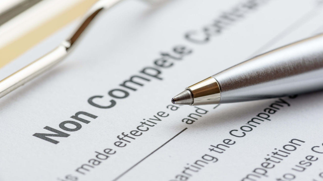 A pen sits on top of a document with the word no complete contract.