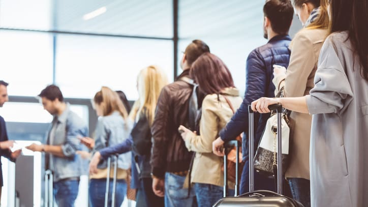 A group of people waiting in line at an airport.