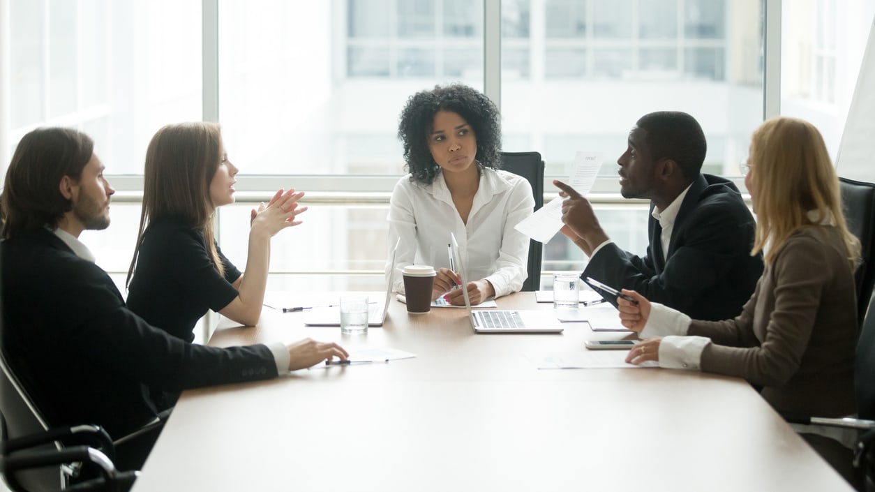 A group of business people sitting around a conference table.