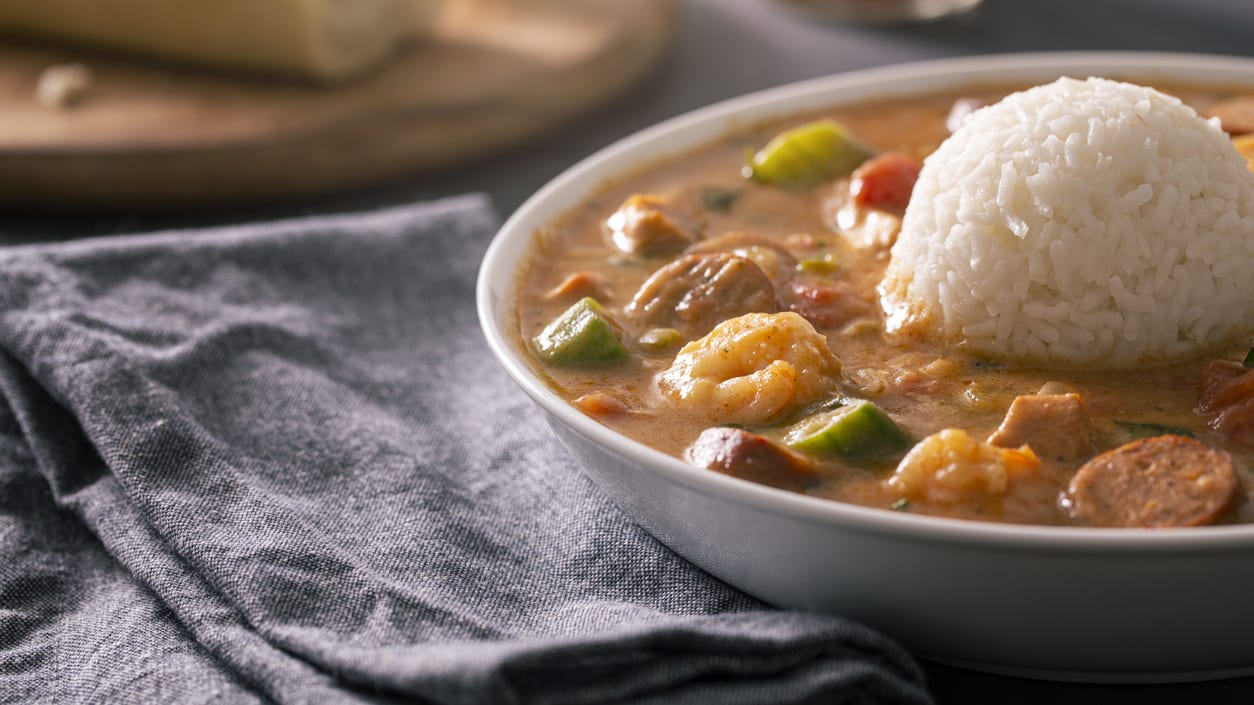 A bowl of crawfish gumbo with rice.