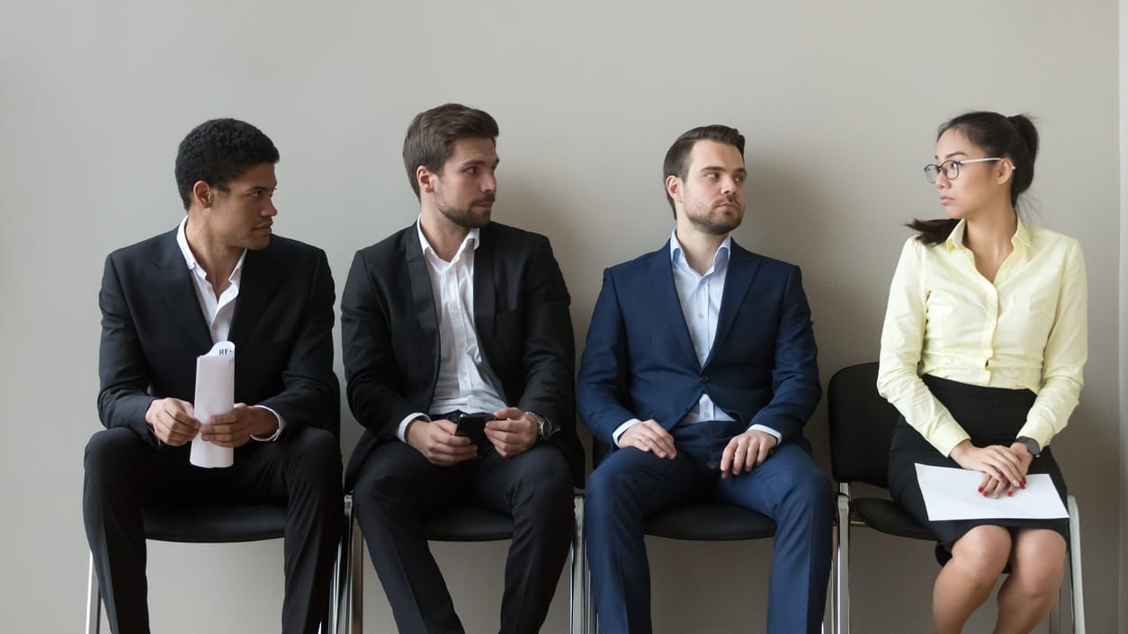 A group of business people sitting in a waiting room.