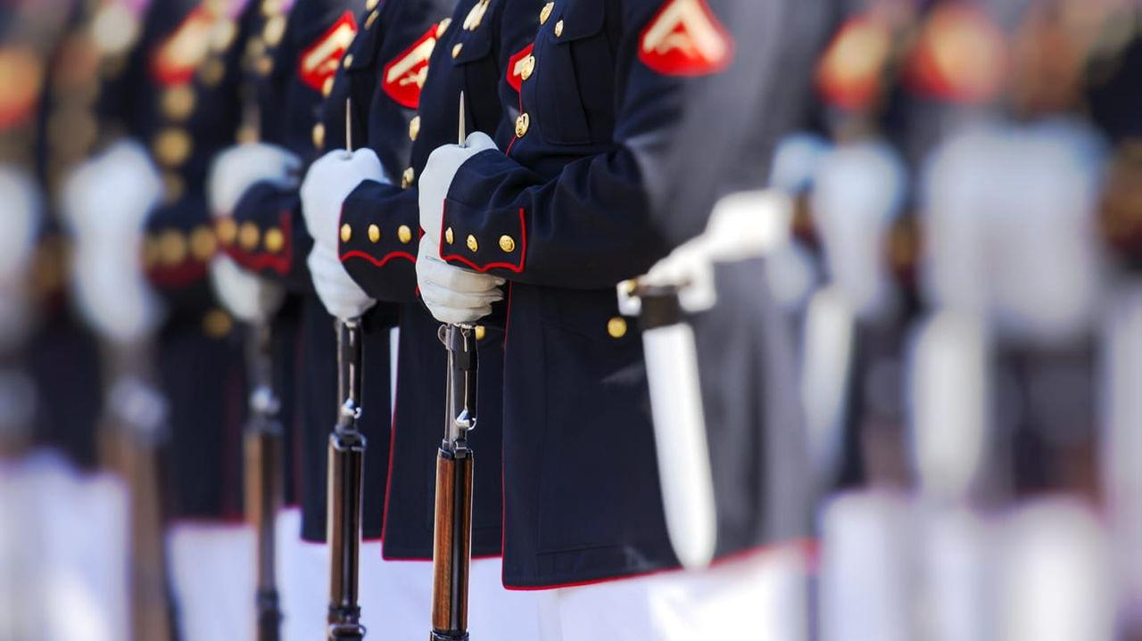 A group of marines in uniform standing in a line.