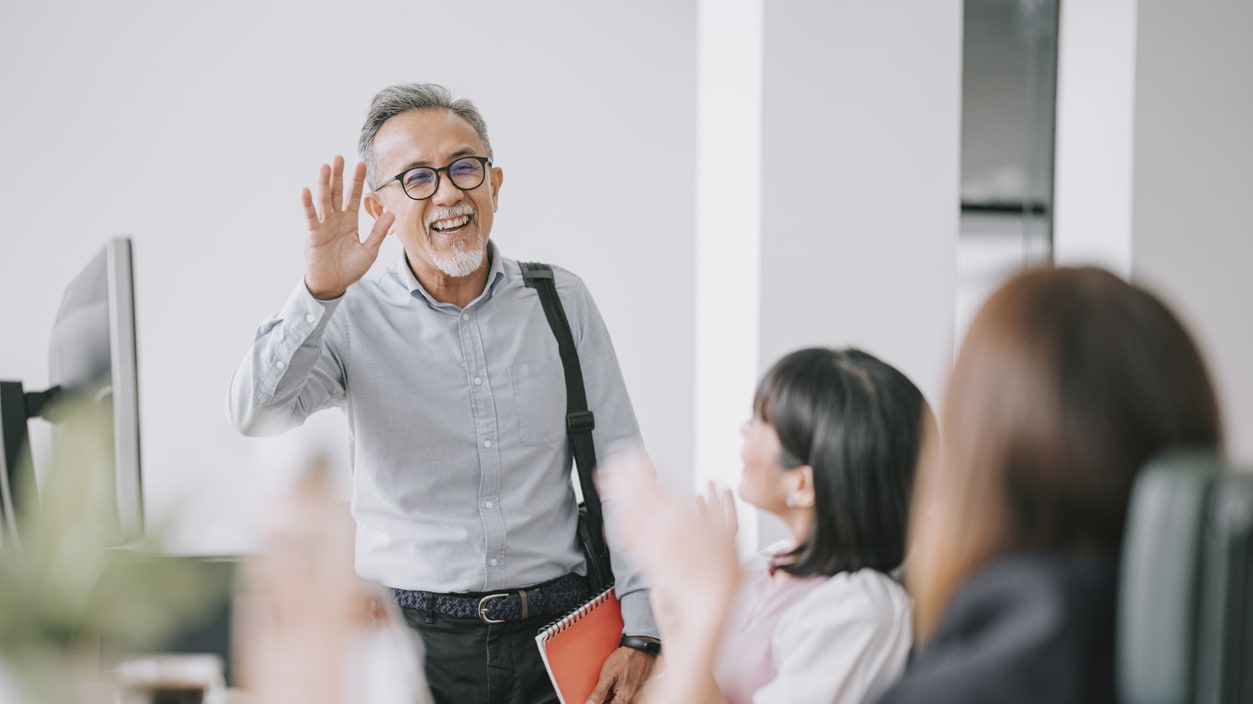 businessman giving a presentation to a group of people in an office.