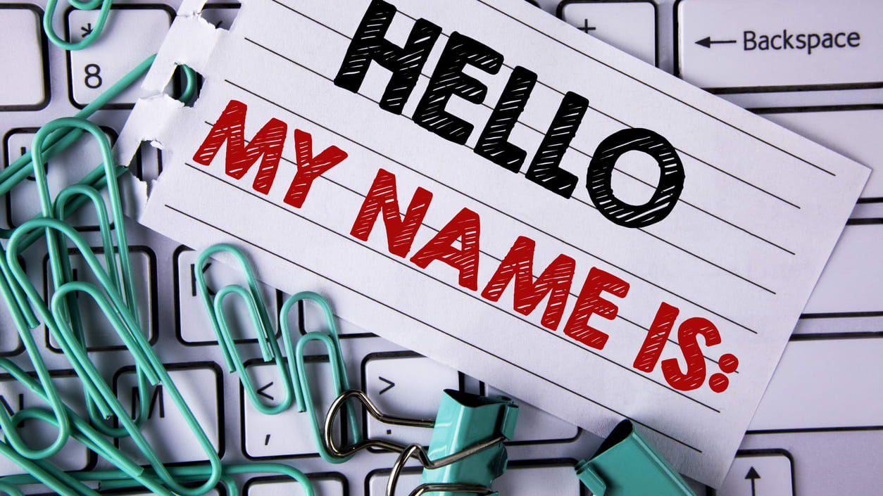 Hello my name is written on a piece of paper next to a keyboard.