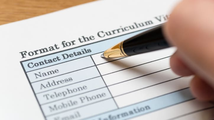 A person filling out a form for the curriculum review.