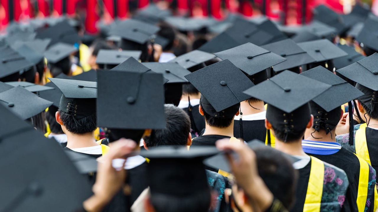 A group of graduates wearing graduation hats.