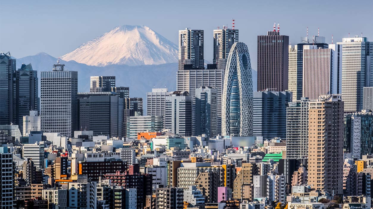 The skyline of tokyo with mount fuji in the background.