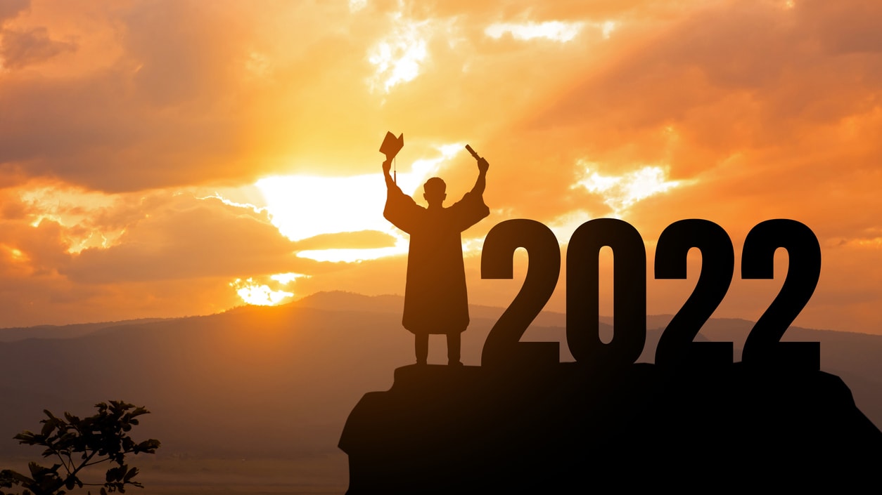 A silhouette of a person standing on top of a mountain with the word 2020 in the background.