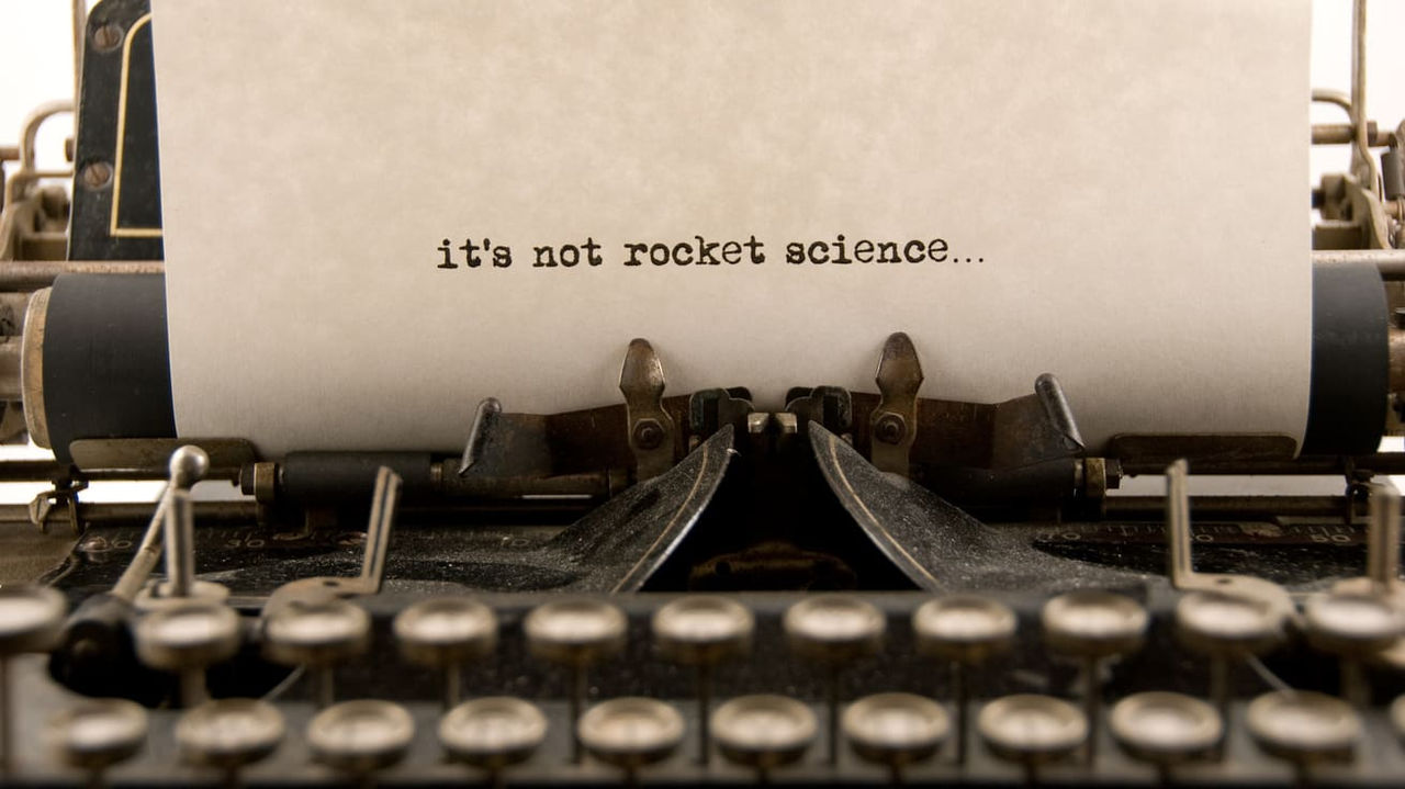 An old typewriter with the words'it's not rocket science'.