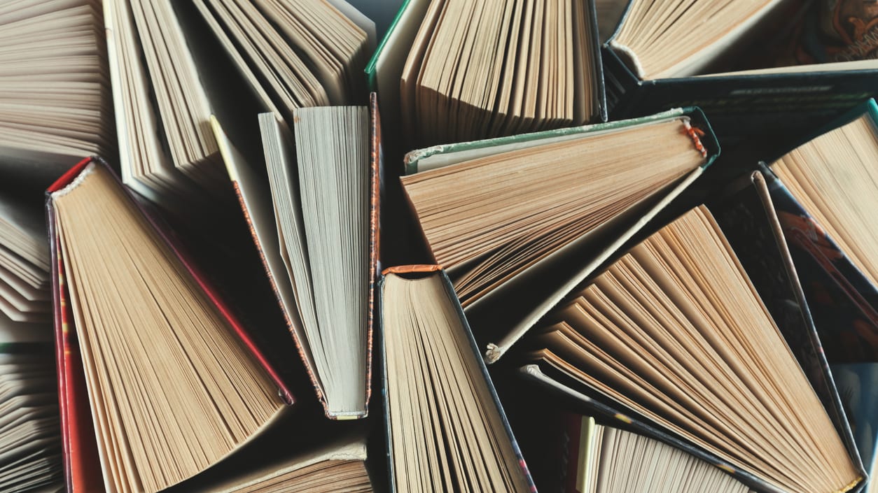 A pile of books on a table.