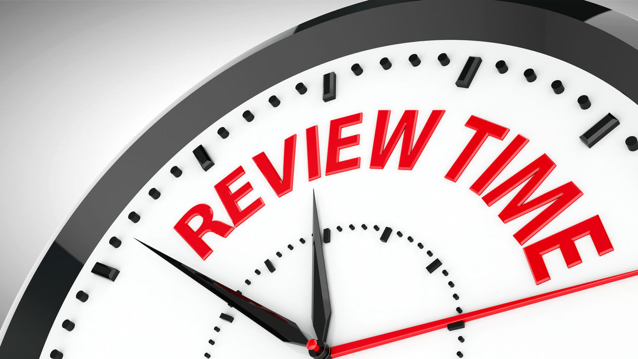 A clock with the word review time on it.