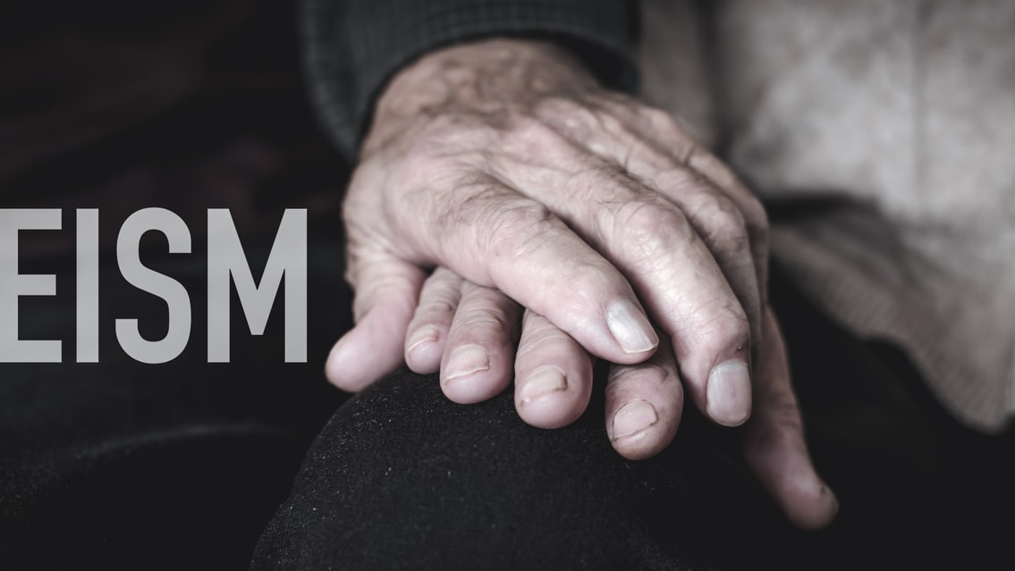 A man and woman holding hands with the word ageism.
