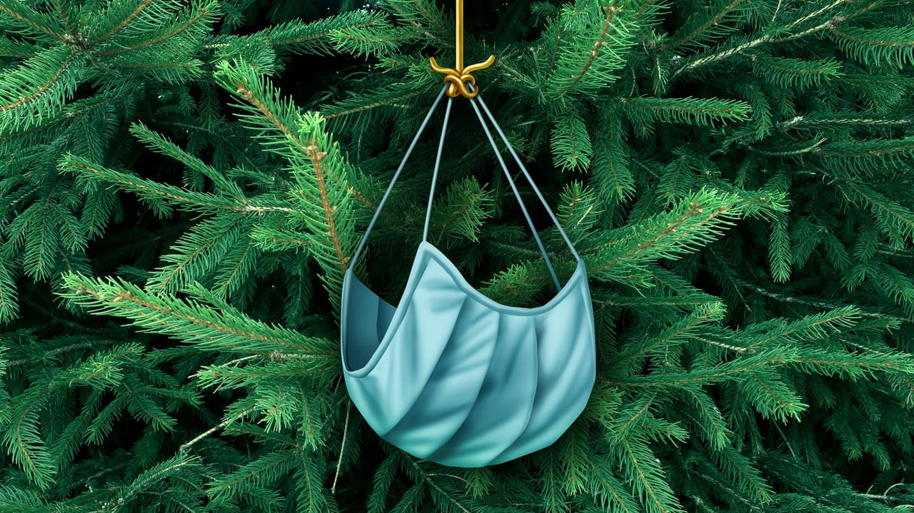 A blue bag hanging from a christmas tree.