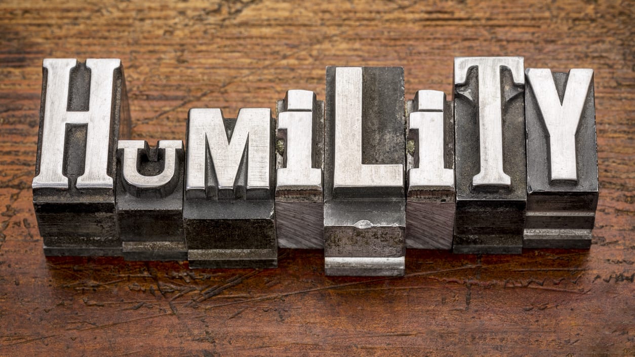 The word humility in metal type on a wooden background.