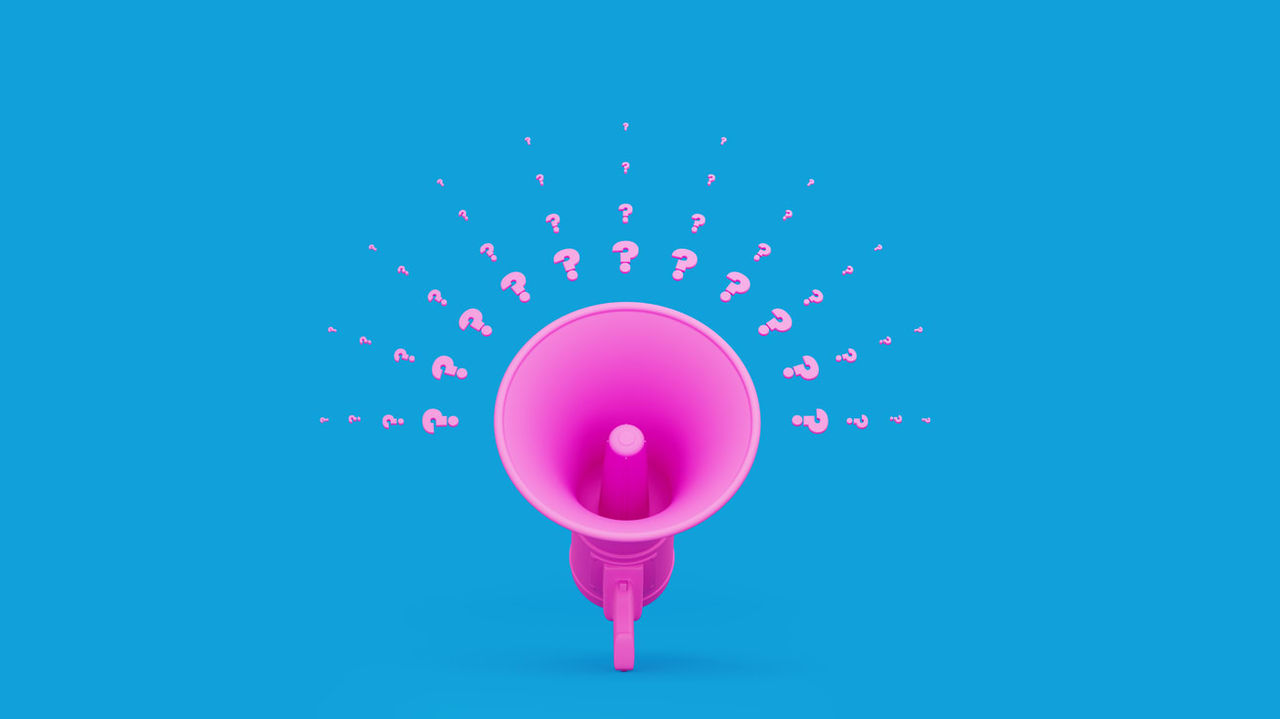A pink megaphone with question marks coming out of it.