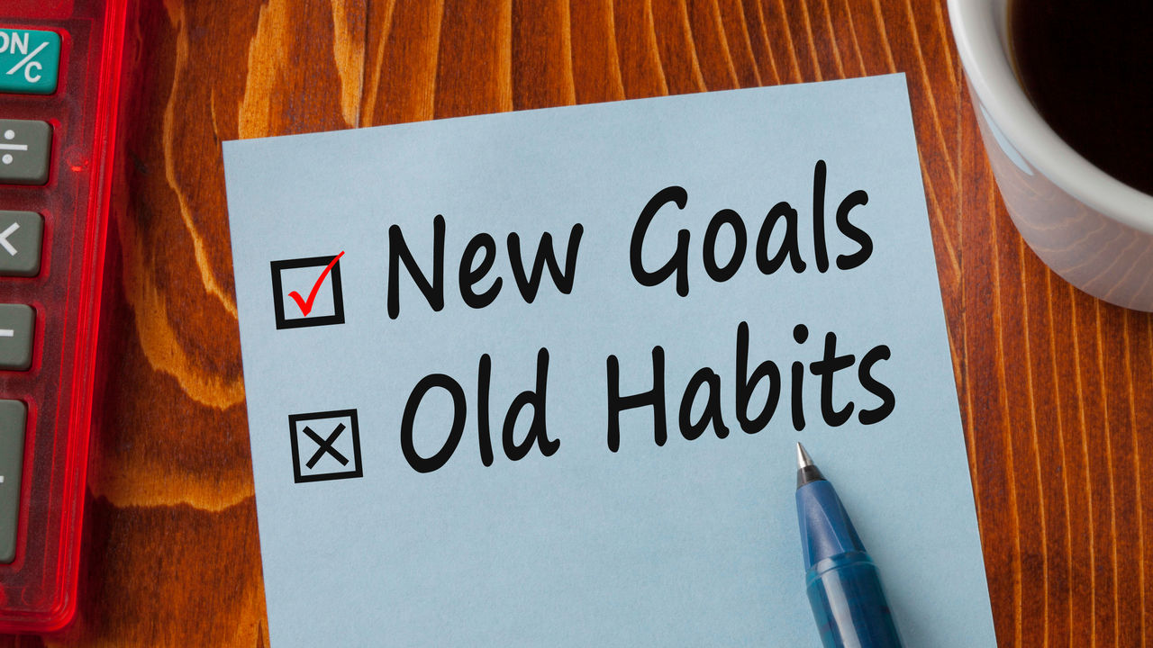 A piece of paper with the words new goals old habits on it.