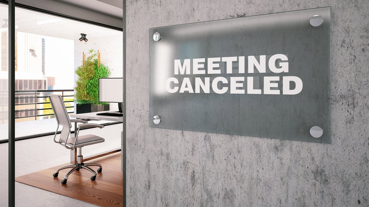A sign that says meeting cancelled in an office.