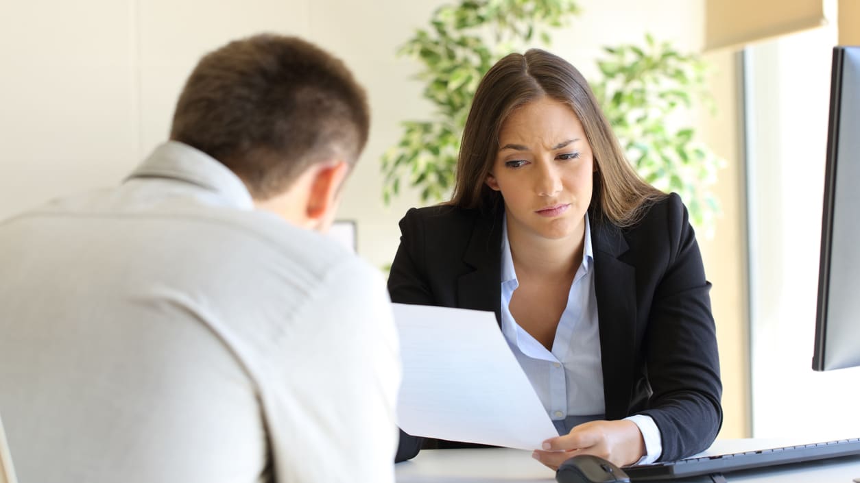 A woman looking at a piece of paper.