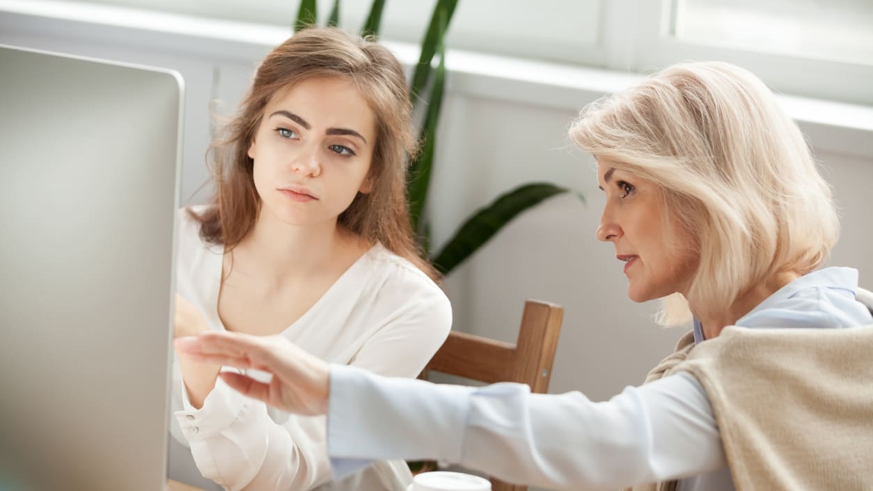 Two women looking at a computer screen.