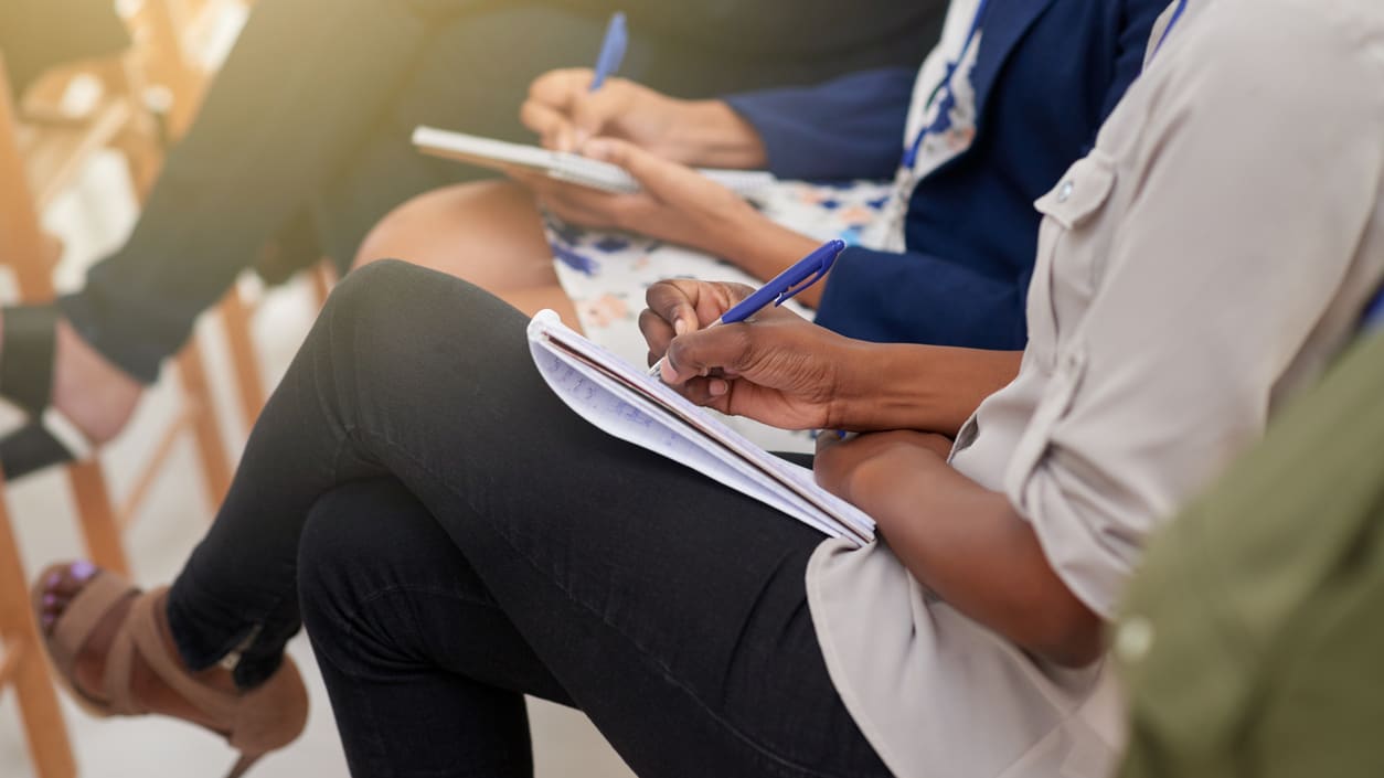 A group of people sitting in a conference room.