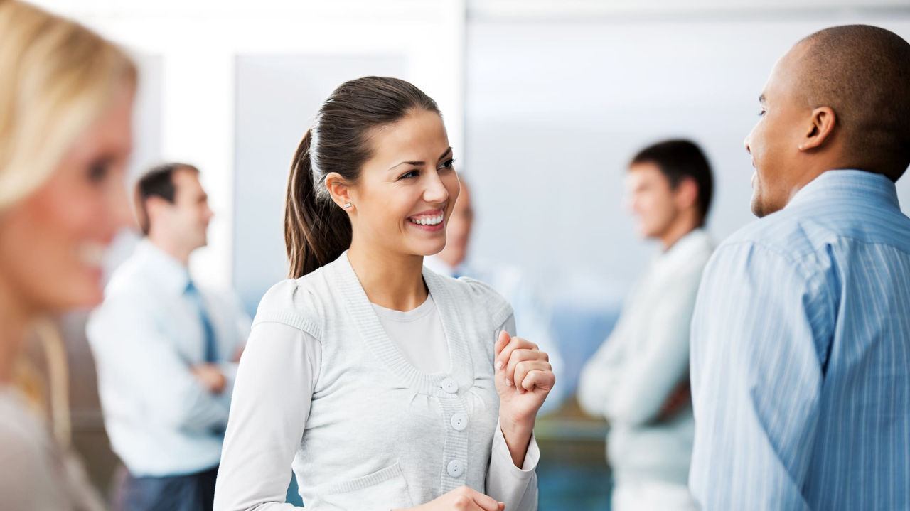 A group of business people talking in an office.