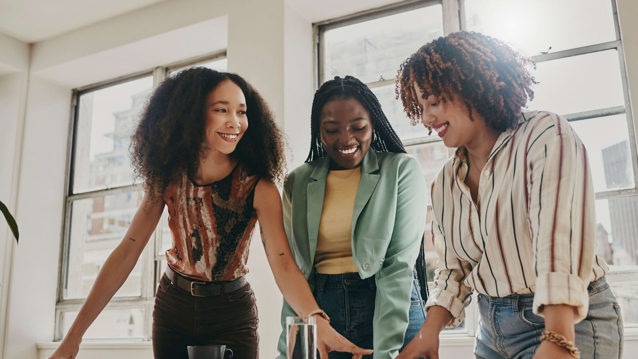 Three women working together in an office.