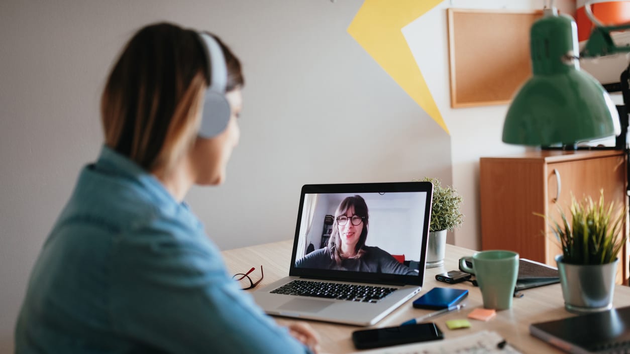 A woman is on a video call with a laptop.