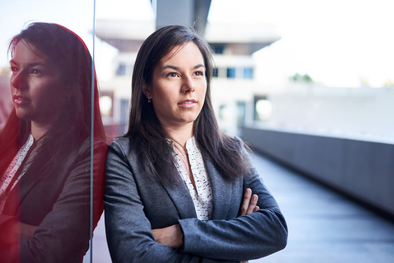 Portrait of a confident, happy female business executive wearing fashionable suit on her way to the next consultant meeting