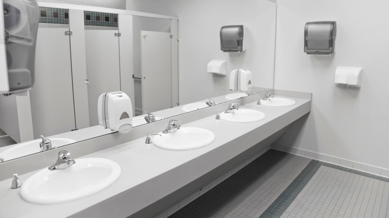 A public restroom with sinks and mirrors.