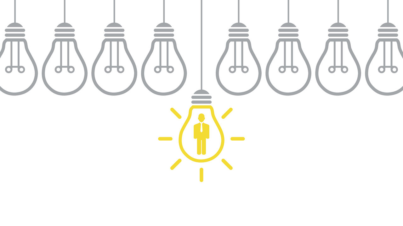 A group of light bulbs with a person in the middle.