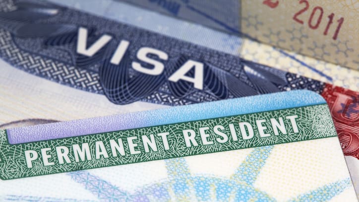 Permanent resident visas are stacked on top of each other.