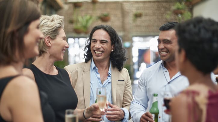 A group of people drinking wine at a party.