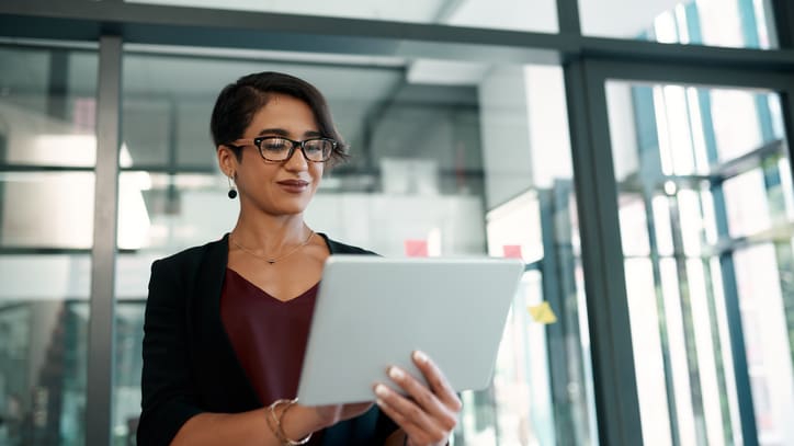 A business woman using a tablet computer in an office.