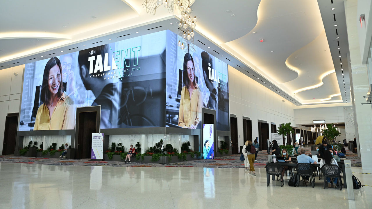 A large lobby with a large screen in the middle.