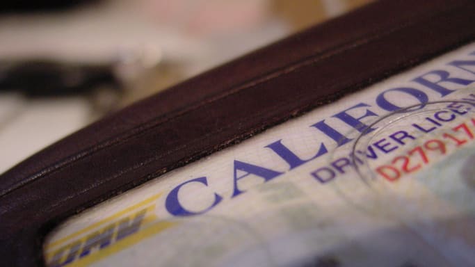 A california driver's license is shown in a wallet.