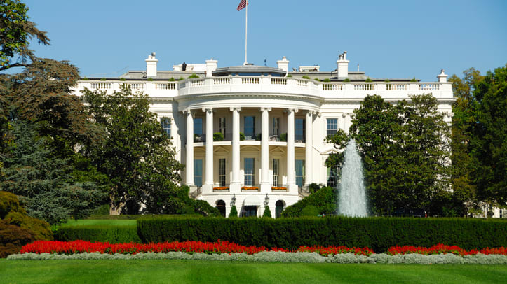 A white house with a fountain.