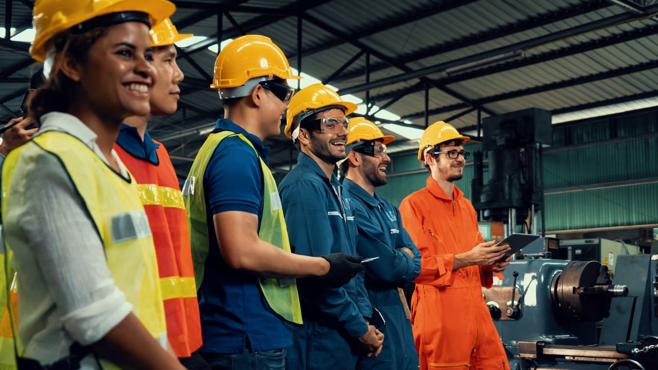 A group of workers standing in a factory.